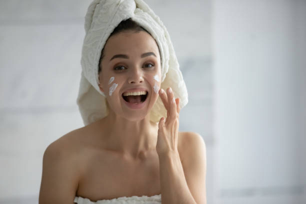istock Young woman apply revitalizing cream on face in bath 1218204769