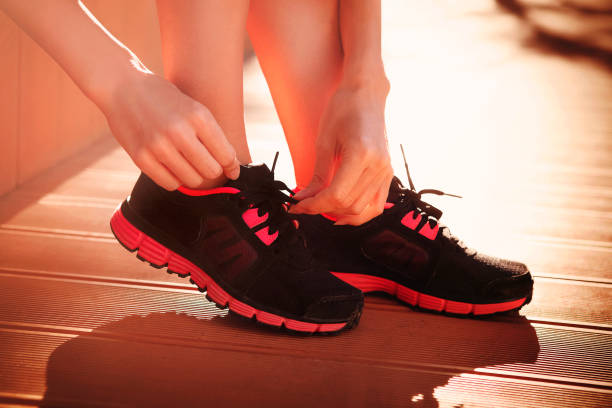 istock Crop woman tying sneakers before workout 1218205066