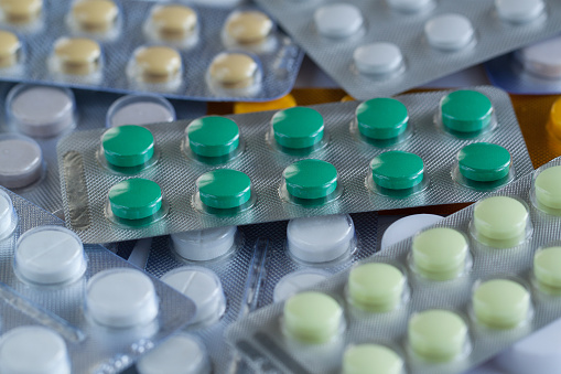 pile of multi-colored tablets in blisters for the prevention and traditional treatment of diseases