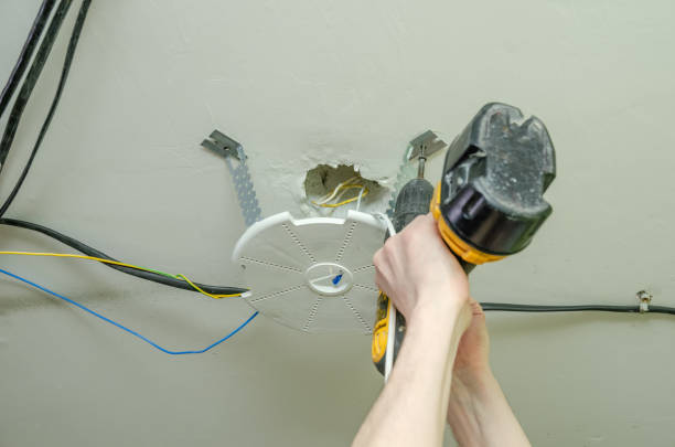 istock repairman installs a platform under a lamp for a stretch ceiling close up 1218205932