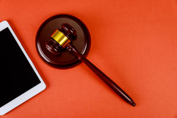 istock Workspace for lawyer with digital tablet blank screen and judges wooden gavel 1218206421