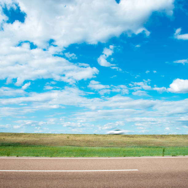 istock Road, grassland and sky with clouds 1218207655