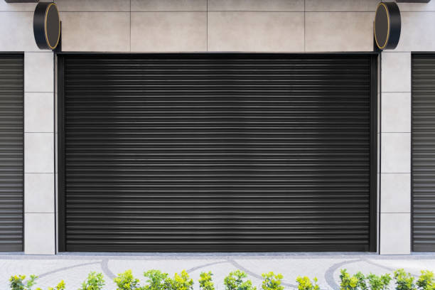 istock Closed Shops black metal roller shutter door. 1218208780