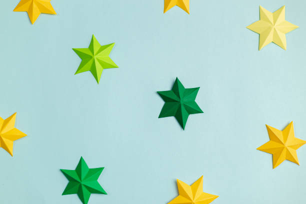 istock Colored paper stars over blue background 1218208789