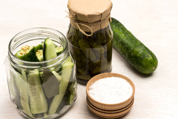 istock Chopped cucumbers in glass jar, salt. Canned cucumbers, 1218208942