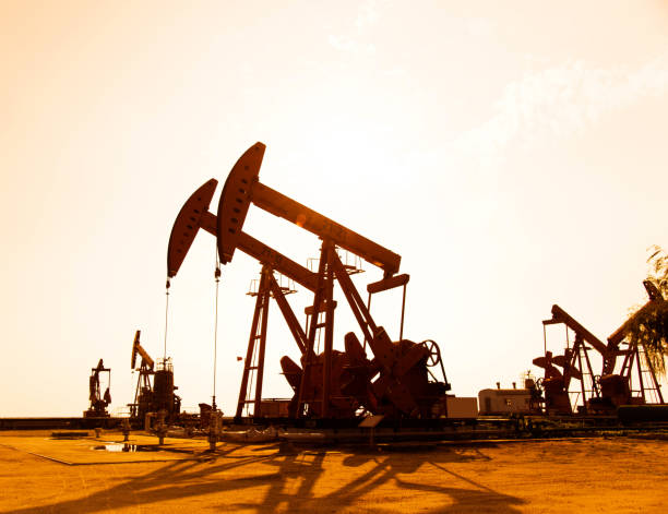 istock Oil pumps and rig at sunset 1218210504