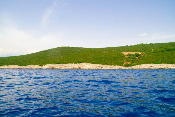 istock Blue sea and green hill. 1218210547