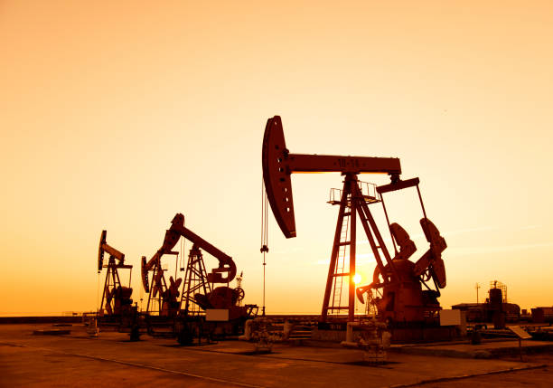 istock Oil pumps and rig at sunset 1218210576