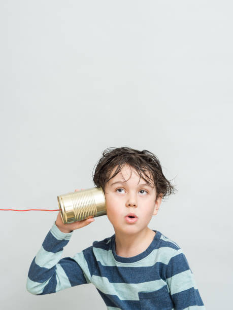 istock Little boy holding a can with a cord 1218211003