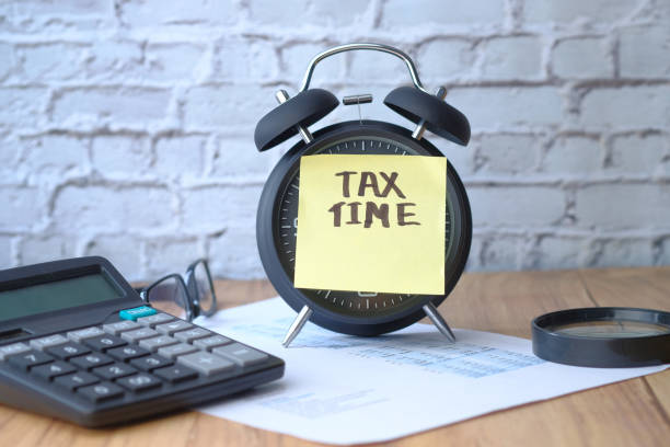 istock pay tax concept with clock and tax word 1218211808