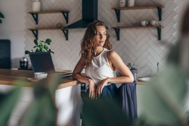 istock Young female entrepreneur sits at kitchen table 1218212231