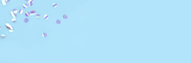 istock Pearl confetti on blue background. 1218212994