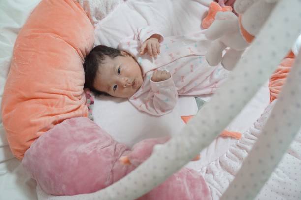 baby playing in the baby gym One month old baby playing in the baby gym. 0 1 months stock pictures, royalty-free photos & images