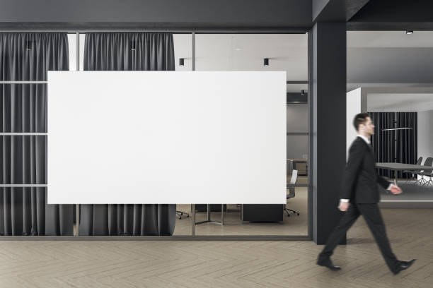 istock Businessman walking in modern coworking office interior 1218214559