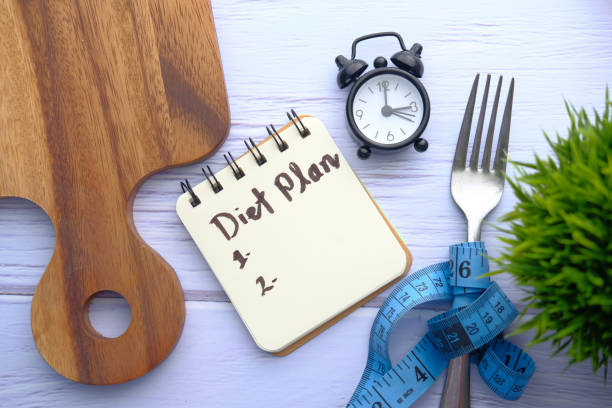 istock Notepad on chopping board with wooden fork and spoon 1218214661