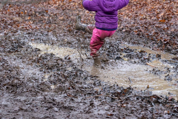 istock Young children playing in a mud puddle 1218215166