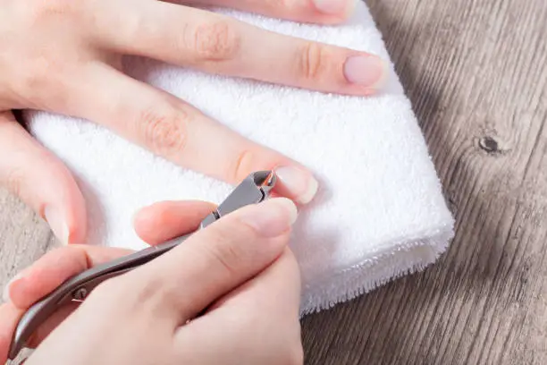 A woman does a manicure at home. Manicure tools. Edged manicure. Dangerous manicure. Home care, Spa, beauty. Nail salon