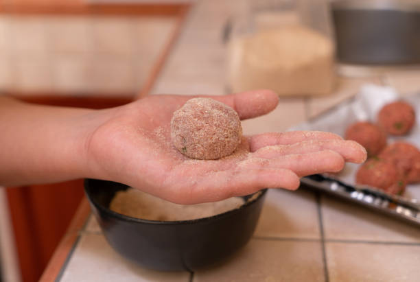 istock Raw beef meatball on the hand 1218216135