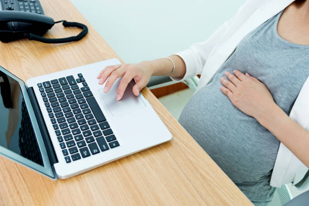 istock Pregnant woman working on laptop 1218216278