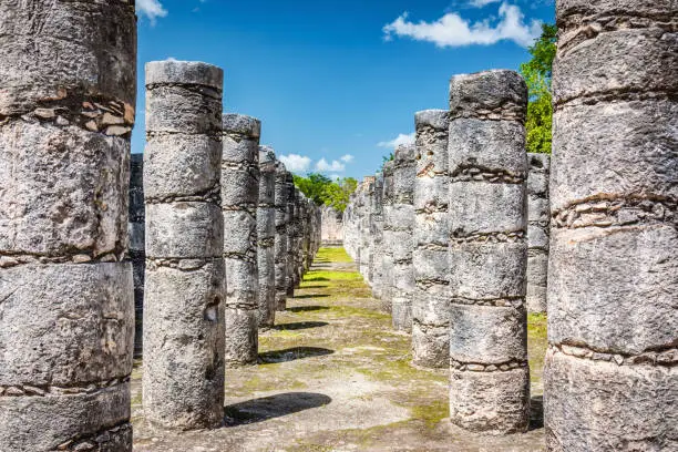 Mil Columnas - Thousand Columns at Mayan Temple of Warriors - Templo de los Guerreros in Chichen Itza under blue skyscape. Chichén Itzá, Yucatan, Mexico, North America.