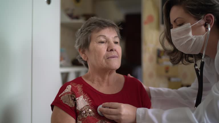 Health visitor and a senior woman during home visit