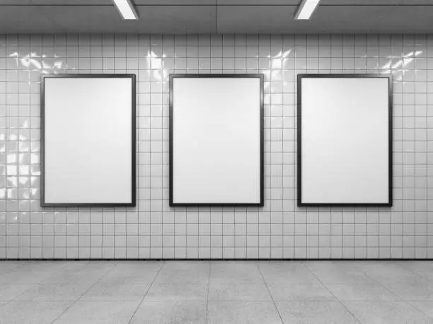 Three blank poster in public place. Vertical light box mockup on subway station. 3D rendering.
