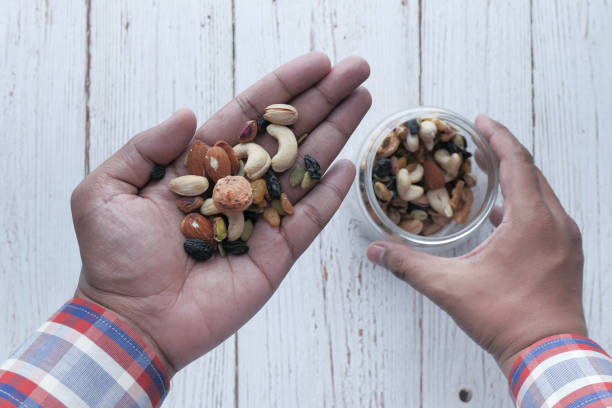 istock top view of mixed nut on man hand 1218222574