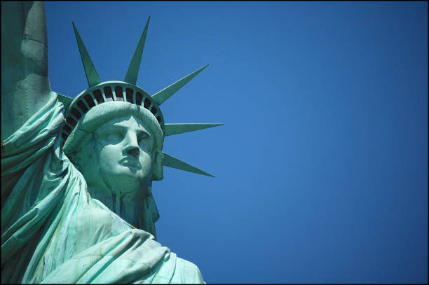 The Statue of Liberty against the blue sky stock photo