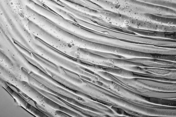 istock Clear light transparent water cosmetic dark grey gel tonic multi-colored background 1218226165