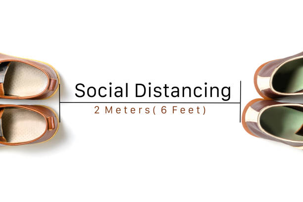 Two leather shoes keep spaced between each other for social distancing isolated, Concept of staying physically apart for infection control intended to stop or slow down the spread of COVID-19 conoravirus