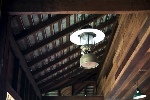 istock Old rustic lantern is hanging on wooden roof 1218226811