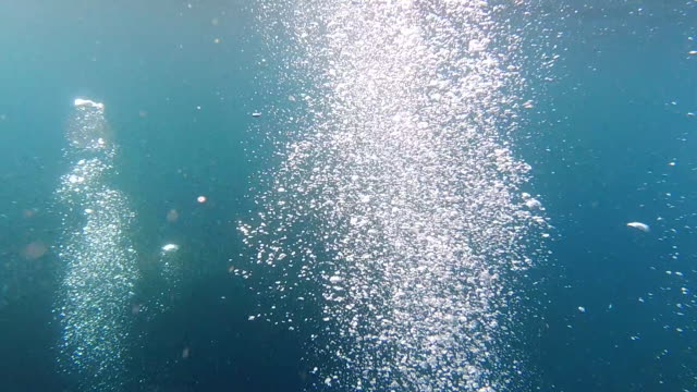 Swimming Underwater Through Air Bubbles