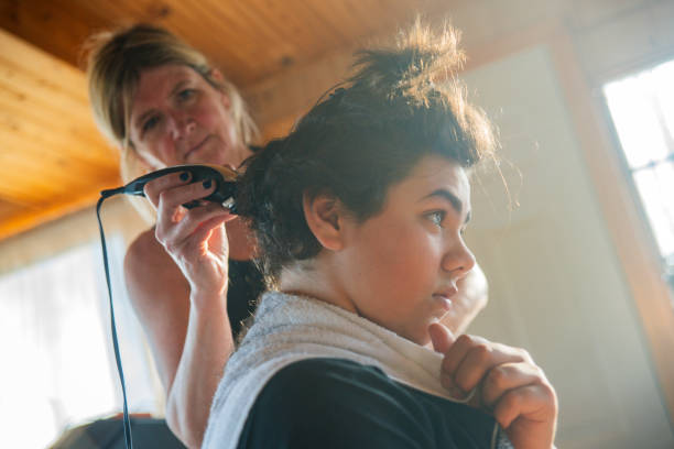 istock A mother cutting her son's hair at home during isolation. 1218228328