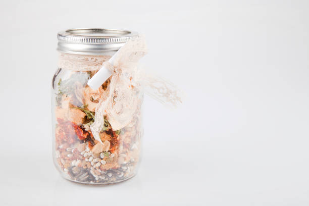 Dry soup preparation in glass jar isolated on white background.