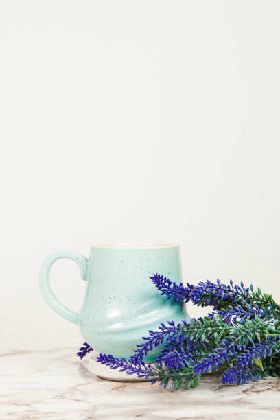 istock Lavender flowers and pastel blue mug on a marble table 1218229579