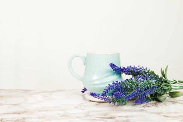 istock Lavender flowers and pastel blue mug on a marble table 1218229673