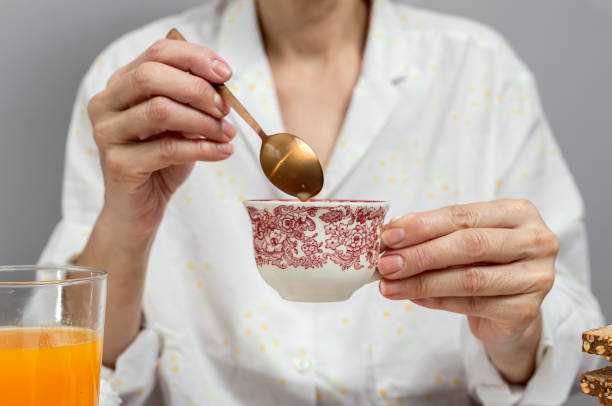 istock Unrecognizable woman having breakfast in pajamas at home in quarantine 1218230213