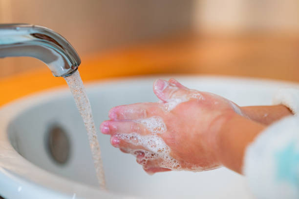istock Close up child is washing hands 1218230839