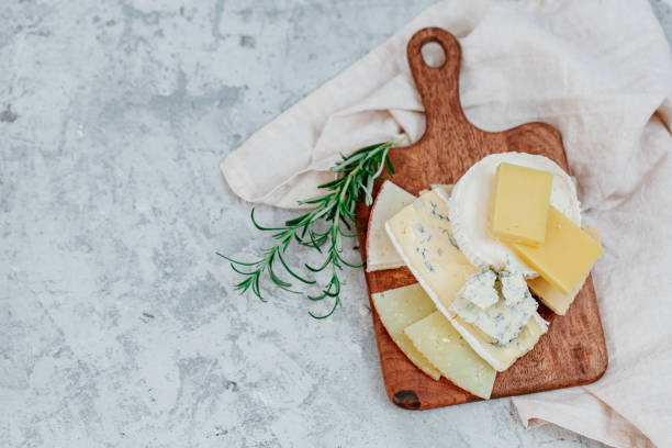 istock Wooden board with different kinds of delicious cheese on table 1218231818