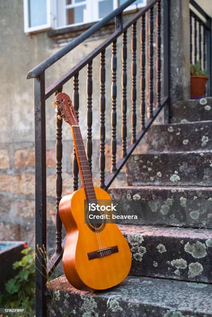 Vertical view of spanish guitar as leisure concept in the countryside. Country music concept. Rural holidays in the south of Spain, in Seville. Musical relax spanish holidays. Travel to Spain concept. Agricultural Field Stock Photo