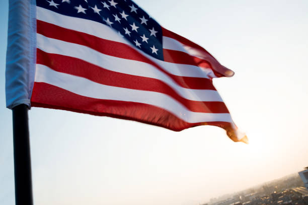 istock American flag waving in sunset 1218232057