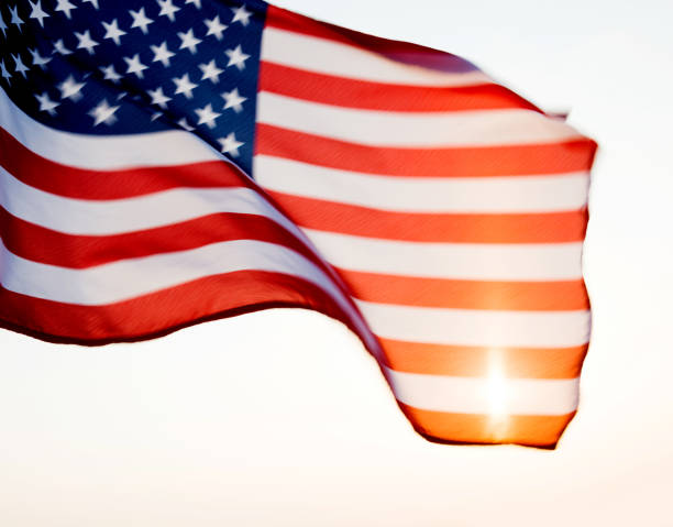 istock American flag waving in sunset 1218232061