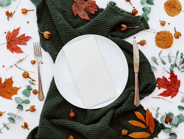 istock Festive table setting with cutlery, eucalyptus branch, porcelain plate. Blank card mockup. Rustic restaurant menu concept. Flat lay, top view 1218232901