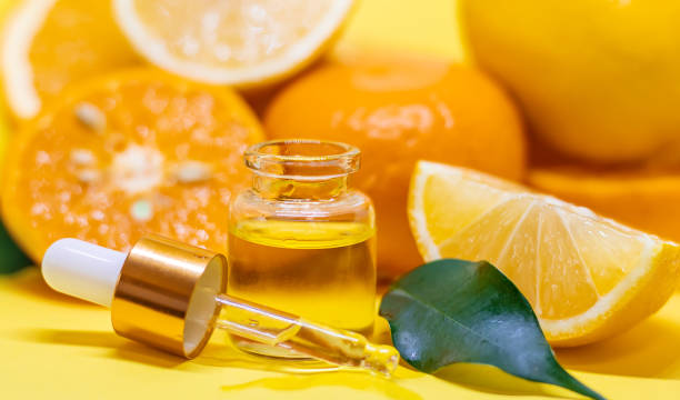 istock orange essential oil on a yellow background. Selective focus. 1218234336