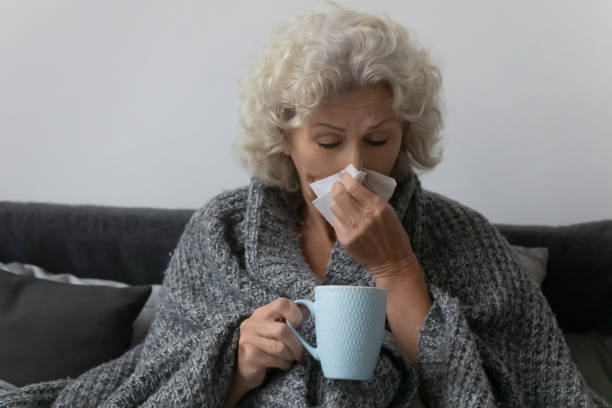 istock Treated at home unhealthy retired lady caught cold. 1218234496