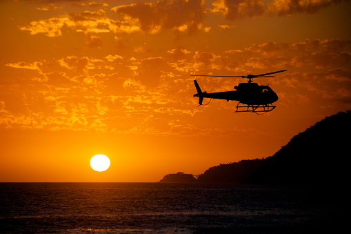 Lifeguard helicopter returning with the day's mission accomplished. Leblon beach, Rio de Janeiro