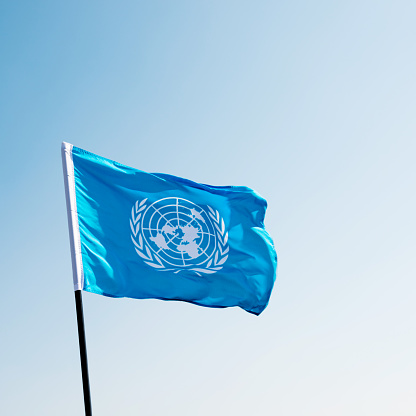 Fujian, China - November 28, 2016: United Nations flag  blowing in the wind.  The United Nations (UN) is an international organization whose stated aims are facilitating cooperation in international law, international security, economic development, social progress, human rights, and achievement of world peace.