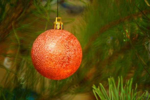Christmas toys on a small tree. Holiday decorations. Christmas balloon. New year and Christmas.