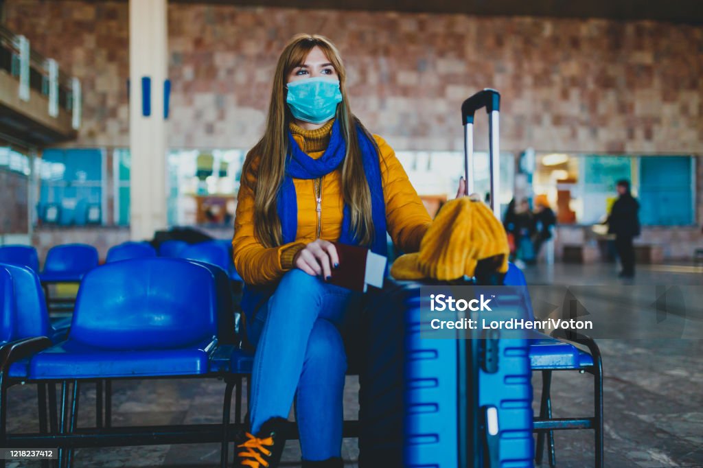 Missed or canceled transport due to a coronavirus Woman at station waiting for missed or canceled transport due to a coronavirus Coronavirus Stock Photo
