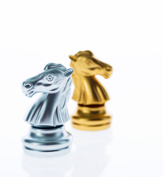 istock Two knight pieces of chess standing back to back 1218237423